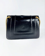 Sac à bandoulière noir en cuir lisse avec chaîne dorée et fermoir tête de serpent